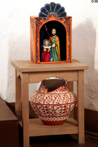 Spanish-style carving of nativity scene over native pot at San Miguel Mission. Santa Fe, NM.