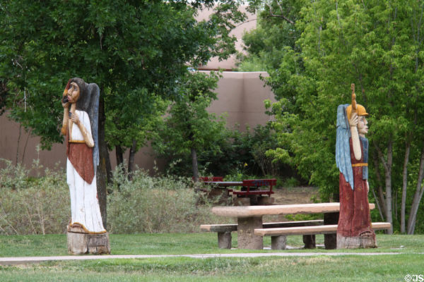 Park along Santa Fe River with carved statues. Santa Fe, NM.