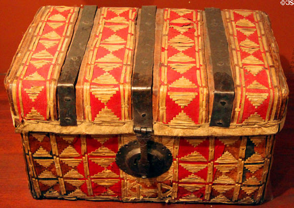 Leather petecas travel chest (17thC) decorated with red bayeta wool from Mexico at New Mexico History Museum. Santa Fe, NM.