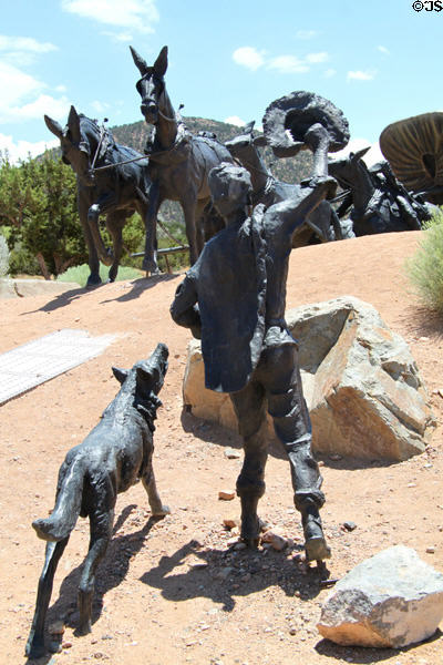 Boy & dog greet new arrival at end of Santa Fe Trail monument. Santa Fe, NM.