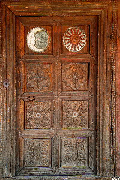 Carved door with moon & sun panels on Mexican Colonial House (c1780) at Museum of Spanish Colonial Art. Santa Fe, NM.