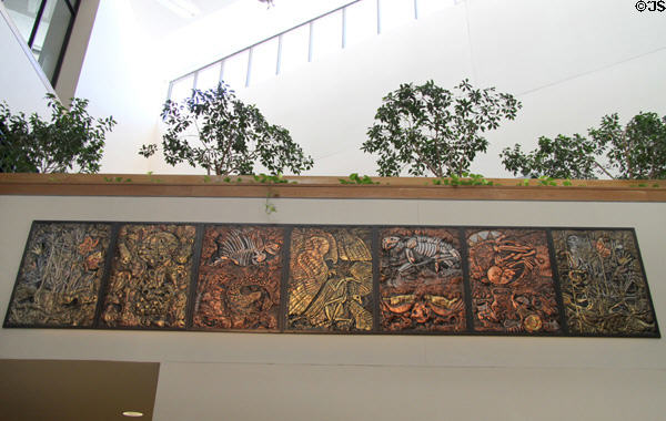 Evolutionary Geoscape II mural with metal sheets over sculpted & natural objects by Evelyn E. Rosenberg at New Mexico Museum of Natural History & Science. Albuquerque, NM.