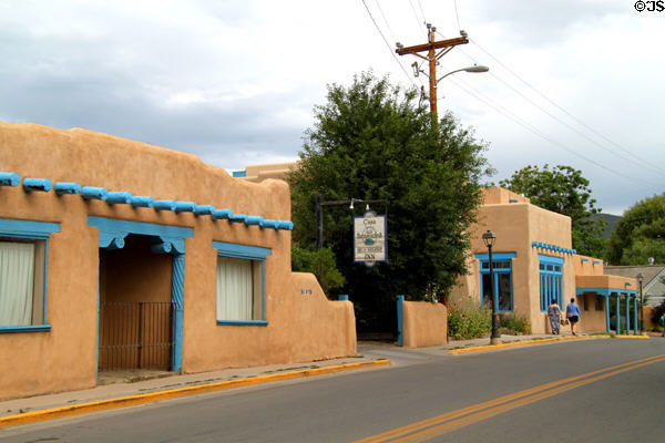 Adobe-style heritage buildings with blue trim (137 Kit Carson Road). Taos, NM.