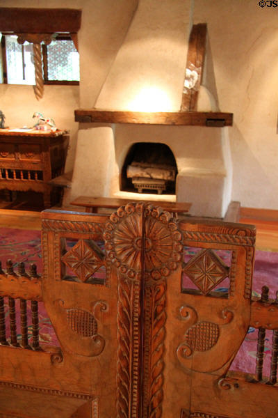 Carved swinging gate by Nicolai Fechin leading to living room at Taos Art Museum. Taos, NM.