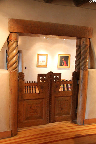 Carved swinging gates on archway at Taos Art Museum. Taos, NM.