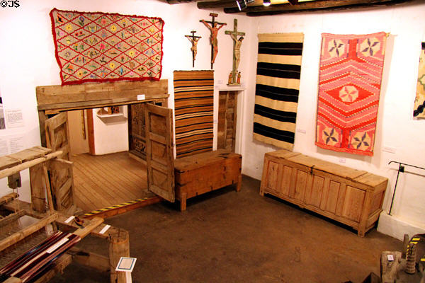 Gallery with textiles & chests at Millicent Rogers Museum. Taos, NM.