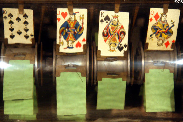 Detail of Draw Poker (1901) showing early slot machines flipped cards on wheel by Fey at Nevada State Museum. Carson City, NV.