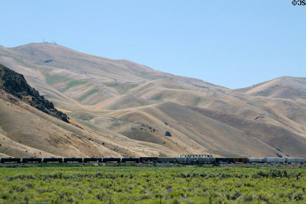 Freight train between barren hills & I-80. NV.
