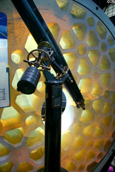 Warner & Swasey refracting telescope (c1881) with first casting of 200-inch glass blank for Palomar Observatory (1934) at Corning Museum of Glass. Corning, NY.