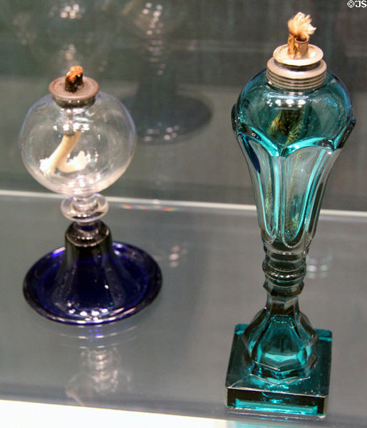 American glass lamp with drip pan (1812-30) from New England & pressed glass lamp (1840-60) at Corning Museum of Glass. Corning, NY.