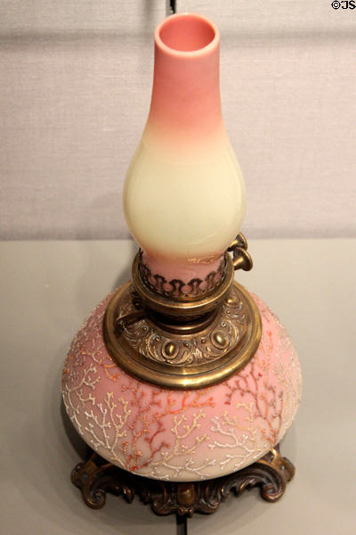Burmese lamp with Coraline decoration (1887-90) by Mount Washington Glass Co. (glass) & Pairpoint Manuf. Co. (mounts) of New Bedford, MA at Corning Museum of Glass. Corning, NY.