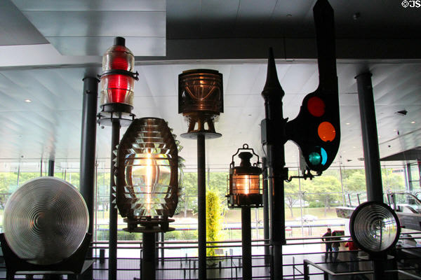 Specialized light glass lenses (l-r) movie studio light (c1940); flashing code beacon to warn of aircraft hazards; Fresnel lighthouse lens; floodlight to guide planes to airport (c1946); lightship lens (c1915); & railroad semaphore (c1920) at Corning Museum of Glass. Corning, NY.