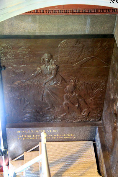 "Mrs. Gen. Schuyler setting fire to her wheat field to prevent its use by the enemy" bronze relief (1885) by J.C. Markham in Saratoga Monument. Schuylerville, NY.