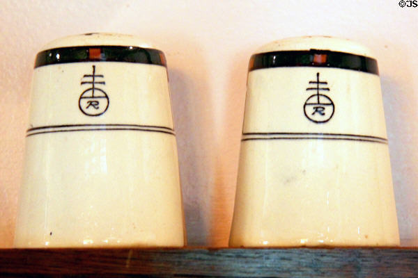 Ceramic salt & pepper shakers with Roycroft logo from Roycroft Inn at Elbert Hubbard Roycroft Museum. East Aurora, NY.