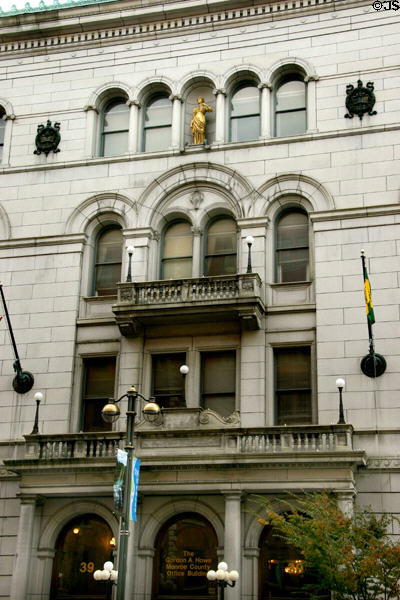 Facade of Monroe County Office Building (1894) with justice statue. Rochester, NY.