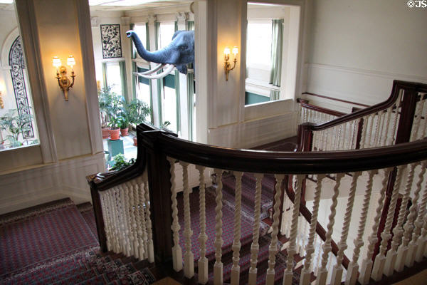 Intricately carved rails of main staircase which overlooks conservatory at Eastman House. Rochester, NY.