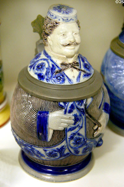Cobalt blue beer stein in form of man with pipe & smoking jacket from Germany at The Strong National Museum of Play. Rochester, NY.
