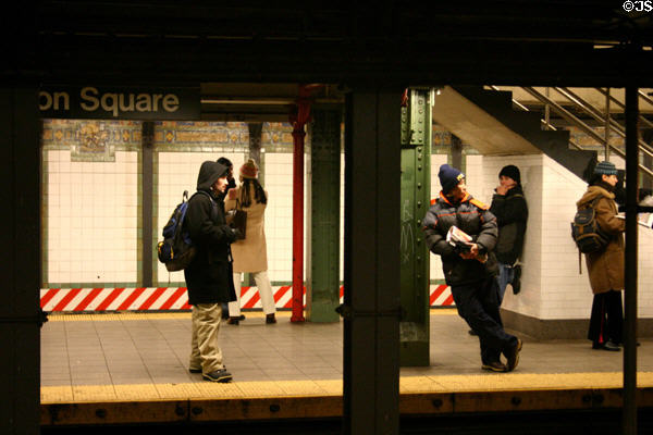 People wait for subway train at Union Square station. New York, NY.