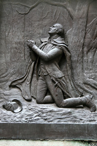 Relief of General George Washington praying for victory in snowy forest on wall of Federal Hall. New York, NY.