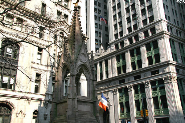 Gothic churchyard spire with Trinity & Equitable Buildings. New York, NY.