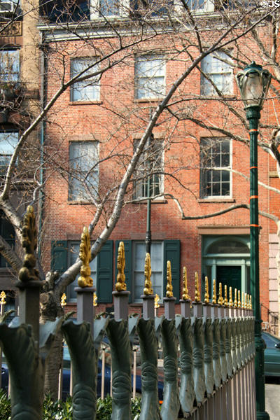 Antique cast-iron fence with Stuyvesant-Fish House. New York, NY.