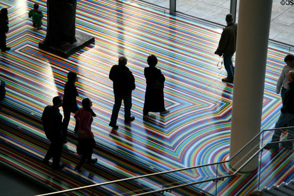 Museum of Modern Art patrons walk across rainbow-colored super graphic. New York, NY.
