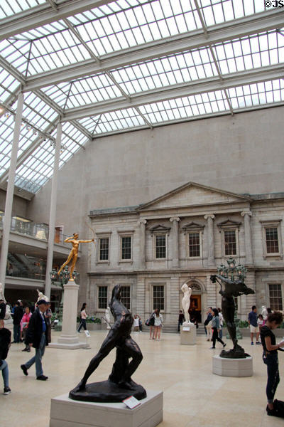 Sculpture gallery seen against Greek revival Bank of the United States building front under skylight at Metropolitan Museum of Art. New York, NY.