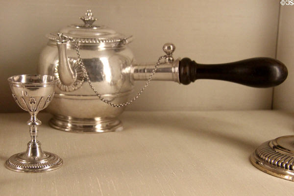 Silver teapot (1699-1700) by I.C. French of Paris beyond French egg cup (c1720s) at Metropolitan Museum of Art. New York, NY.