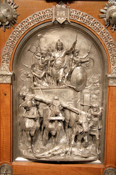 Detail of plaque of King Merovech over forces of Attila the Hun in 451 on veneered armoire (1867) by Jean Brandely, Charles-Guillaume Diehl & Emmanuel Frémiet of Paris (made for Paris Exposition Universelle of 1867) at Metropolitan Museum of Art. New York, NY.