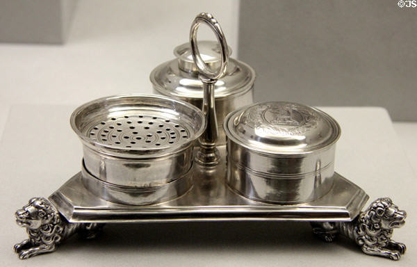 Silver triangular ink stand supported of lions (1710-20) by John Coney of Boston at Metropolitan Museum of Art. New York, NY.