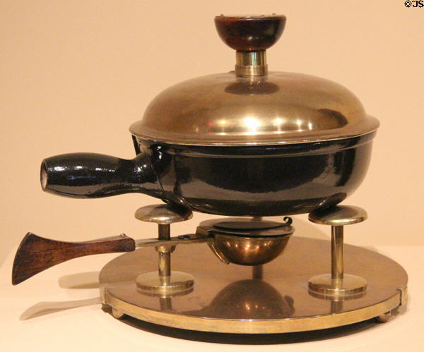 Brass, Oak & stoneware Arts & Crafts chafing dish (1900) by Charles Rohlfs of Buffalo, NY at Metropolitan Museum of Art. New York, NY.