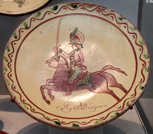 Redware sgraffito plate with Light Dragoon soldier (1820-50) from Pennsylvania at Metropolitan Museum of Art. New York, NY.