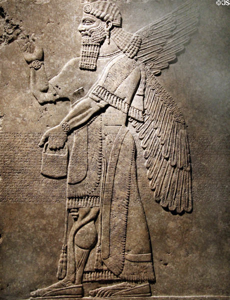 Assyrian relief of winged genie with fancy bracelets (883-859 BCE) from King Ashur-nasir-pal II palace of Nimrud at Brooklyn Museum. Brooklyn, NY.