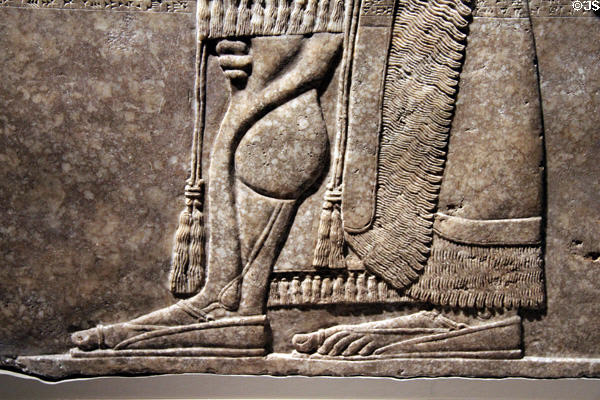 Detail of Assyrian relief of winged genie with fancy bracelets (883-859 BCE) from King Ashur-nasir-pal II palace of Nimrud at Brooklyn Museum. Brooklyn, NY.