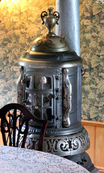 Dining room Stewart Oak cylindrical stove heater Alice Austen House Museum. Staten Island, NY.