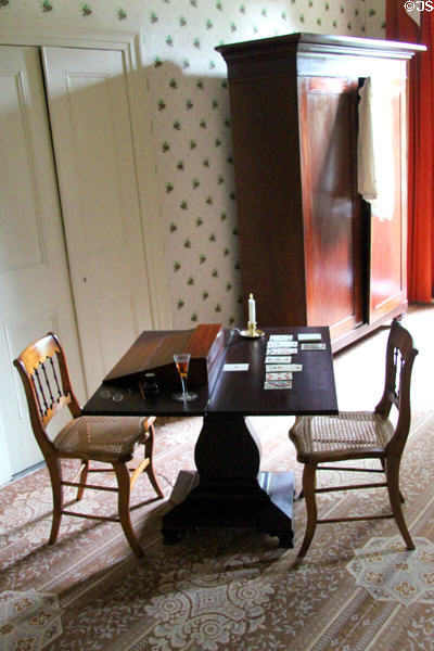 Folding card table (1830-40) & lap desk with late classical style wardrobe (1830-40) beyond at Lindenwald. Kinderhook, NY.