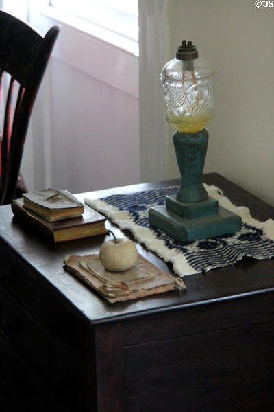 Side table with whale oil lamp in Conklin House at Old Bethpage Village. Old Bethpage, NY.