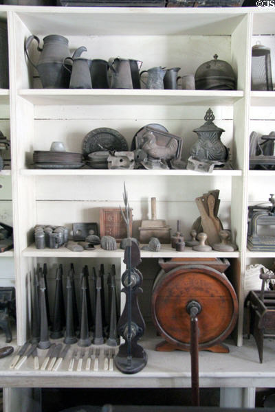 Metal ware pitchers, food molds, ear trumpets & lightning rod in Layton General Store at Old Bethpage Village. Old Bethpage, NY.