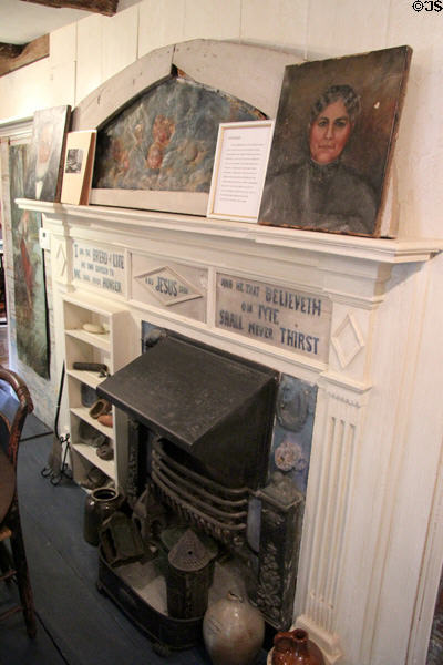 Fireplace surrounded by artwork of Annie Cooper Boyd at Boyd House museum. Sag Harbor, NY.