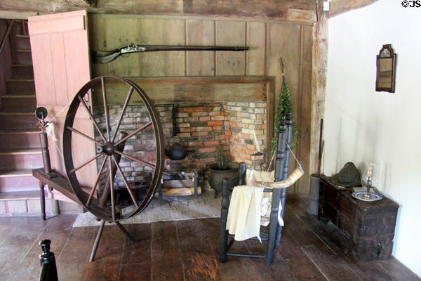 Spinning wheel in front of brick fireplace with ladder-back sidechair at Thomas Halsey Homestead. South Hampton, NY.