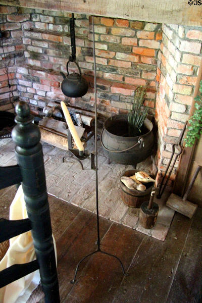Brick fireplace with antique implements plus adjustable height candlestick at Thomas Halsey Homestead. South Hampton, NY.