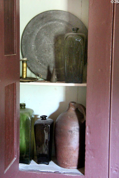Pewter plate, glass bottles & stoneware jug at Thomas Halsey Homestead. South Hampton, NY.