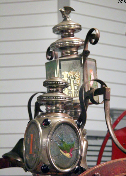 Detail of decorated lamps on fire hose cart (1870) at carriage collection of Long Island Museum. Stony Brook, NY.