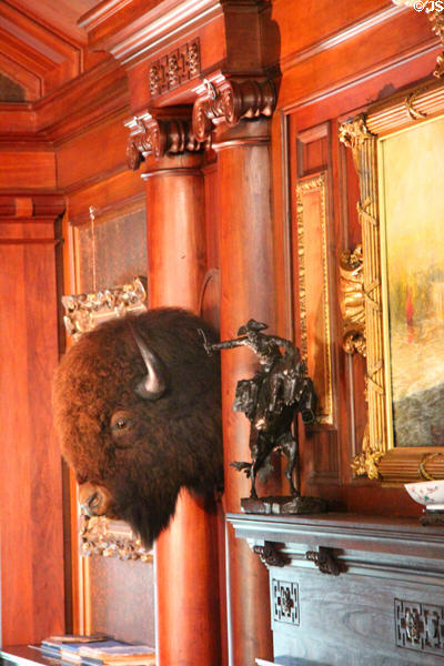 Buffalo head & Remington sculpture by fireplace in North Room at Roosevelt's House Sagamore Hill NHS. Cove Neck, NY.