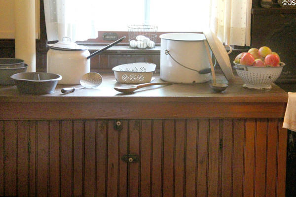 Kitchen counter with enamel pots & strainers at Roosevelt's Sagamore Hill NHS. Cove Neck, NY.