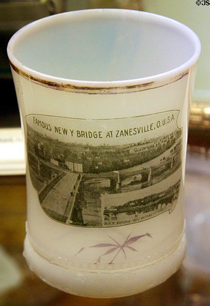 Ring band opal glass tumbler showing Y bridge at Zanesville, OH at National Heisey Glass Museum. Newark, OH.