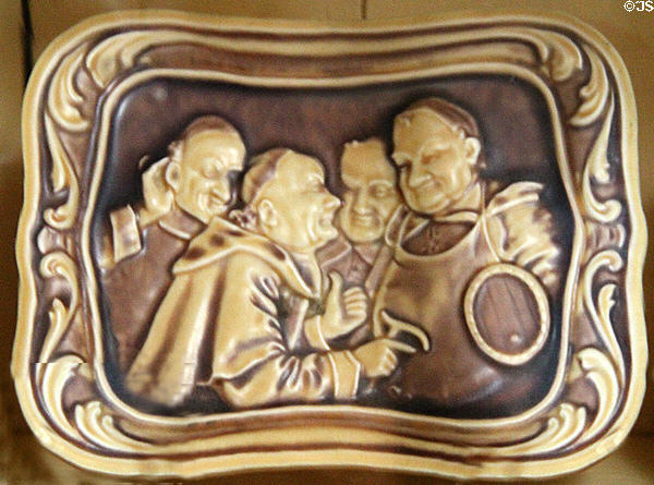 Embossed tray with monks by American Encaustic Tiling Co. at Mathews House Museum. Zanesville, OH.