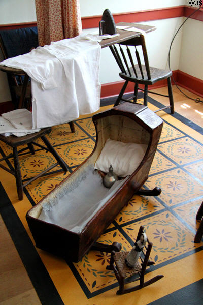 Cradle & ironing board in Whitney home at Historic Kirtland Village. Kirtland, OH.