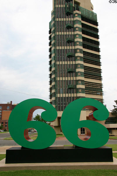 Sixty-six sculpture (2004) by Robert Indiana against Price Tower to mark both Route 66 & Phillips 66 petroleum headquartered in Bartlesville. Bartlesville, OK.