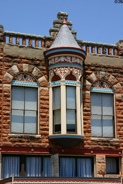 Native red sandstone plus blue & red trim details of De Steiguer building. Guthrie, OK.